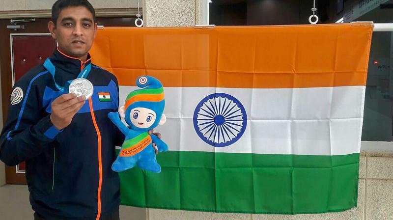 India's Shahzar Rizvi poses for a photograph after winning a silver medal