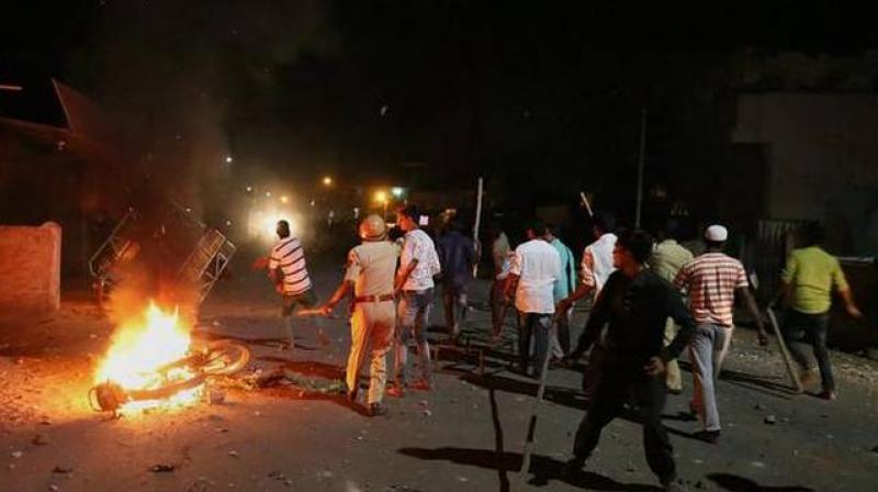 Rioters hurl stones and sticks during a communal riot in Moti Karanja area of Aurangabad