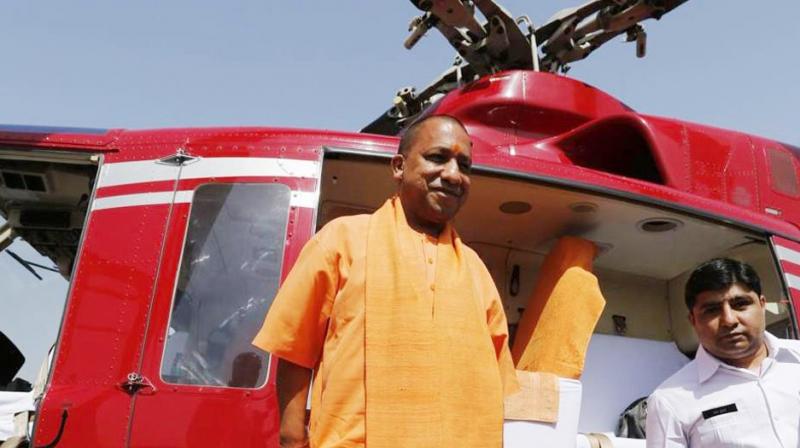 Yogi Adityanath's chopper forced to land on a field in Kasganj Yogi Adityanath's chopper forced to land on a field in Kasganj