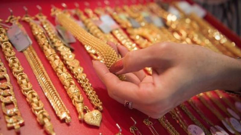 Gold prices were ruling almost flat at Rs 33,370 per 10 gram