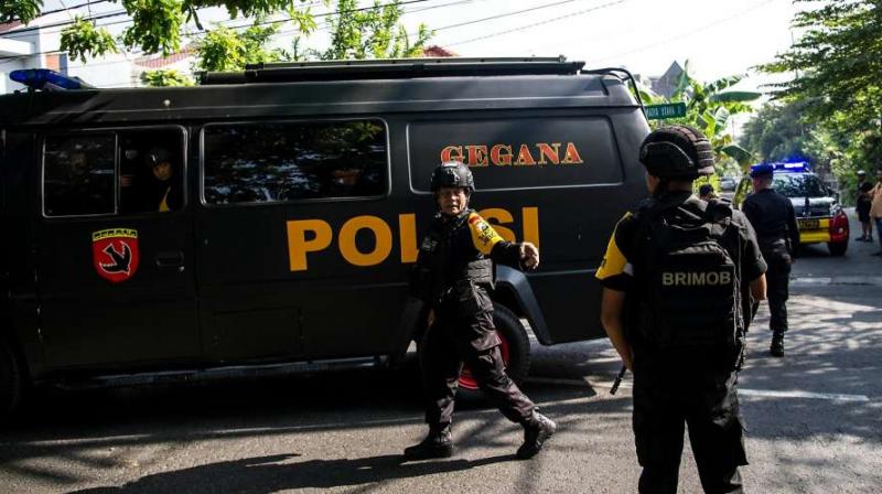 Indonesian policemen patrol outside a church following a suicide bomb Indonesian policemen patrol outside a church following a suicide bomb