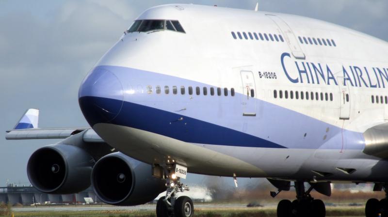 Chinese man detained after he opened the emergency exit on a plane Chinese man detained after he opened the emergency exit on a plane