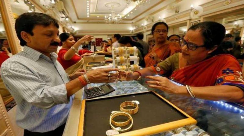Gold prices inched up 