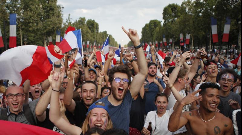 With flags, song, pride, French celebrate unifying victory With flags, song, pride, French celebrate unifying victory