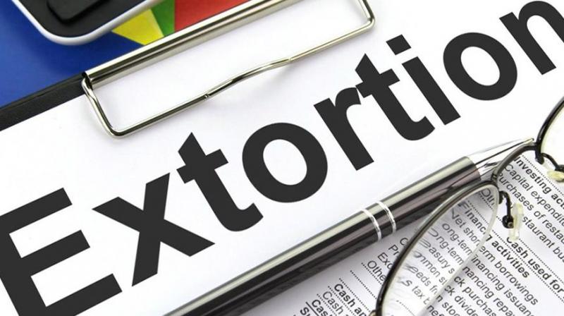 Unidentified men booked for extortion Unidentified men booked for extortion