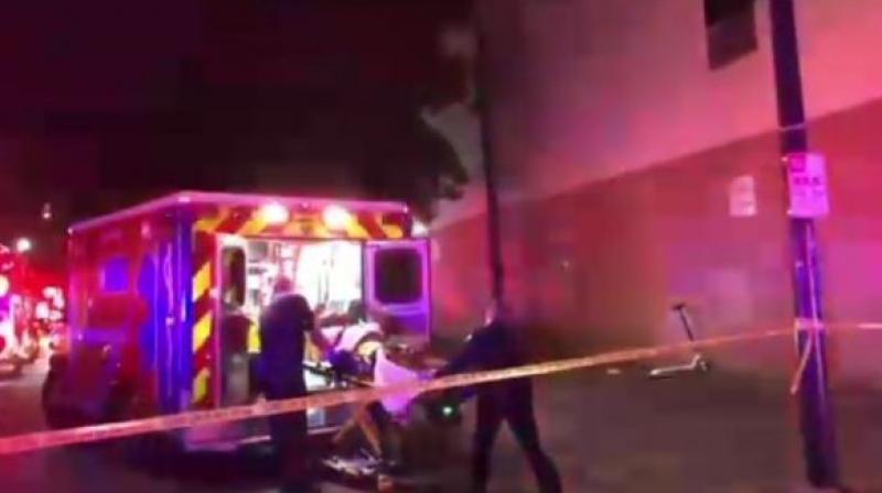 One of five shooting victims is loaded into an ambulance