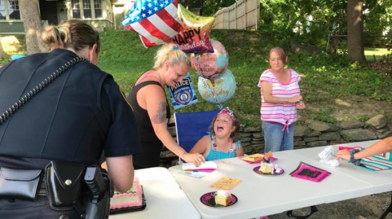 The girl received a birthday card signed by the entire police department with several gifts The girl received a birthday card signed by the entire police department with several gifts