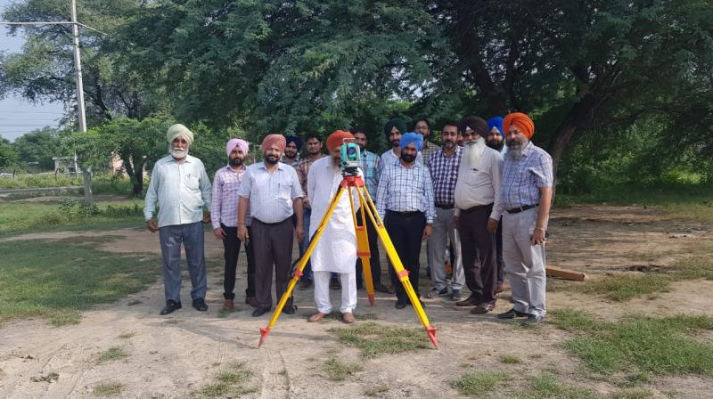 Punjab Revenue Department officials demarcating a land with Theodolite machine Punjab Revenue Department officials demarcating a land with Theodolite machine