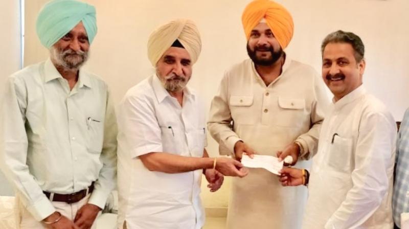 Tript Bajwa hands over 55 lakh cheque Tript Bajwa hands over 55 lakh cheque