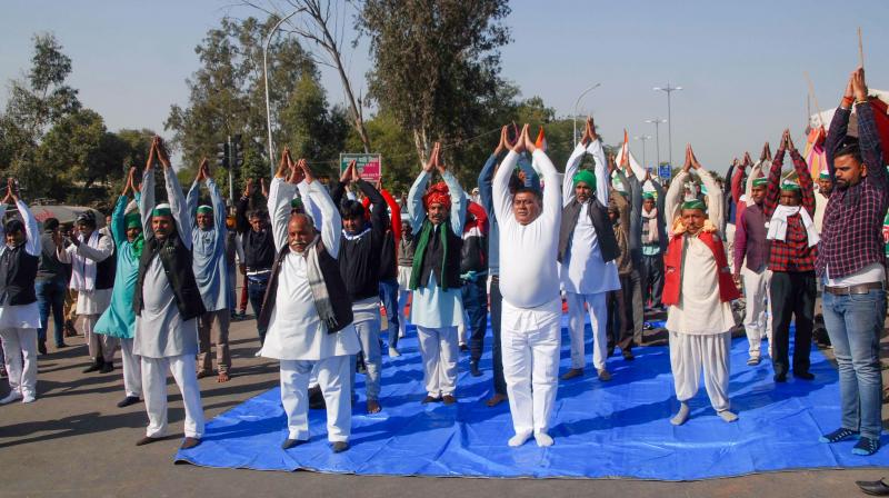 Protestors do yoga on highway Protestors do yoga on highway