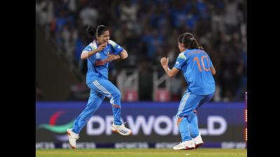 India's Renuka Singh, right, and Amanjot Kaur celebrate the wicket of South Africa?s Tazmin Brits during the ICC Women's World Cup final ODI cricket match between India Women and South Africa Women, at the DY Patil Stadium, in Navi Mumbai, Sunday, Nov. 2, 2025. (PTI Photo/Kunal Patil)  Cricketer Amanjot Kaur's Family in Punjab to Give Her a Grand Welcome After India's Women's World Cup Win