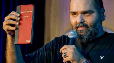Kunal Kamra Refuses to Apologize; Eknath Shinde Reacts: ‘Satire Has Limits'. Comedian Kunal Kamra, at the end of show, holds up a copy of the Constitution of India during his stand-up special Naya Bharat. Emphasizing the importance of free speech, he remarks, “This allows me to do what I do. In the framework of this book, you can feel free to do anything.” Kamra’s statement highlights his belief in constitutional rights, particularly freedom of expression, amid ongoing debates about the limits of satire in India.
