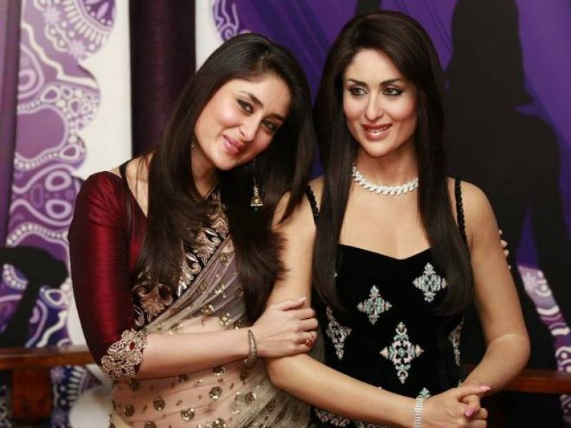 Bollywood actress Kareena Kapour, left, poses next to her wax work at Madame Tussauds