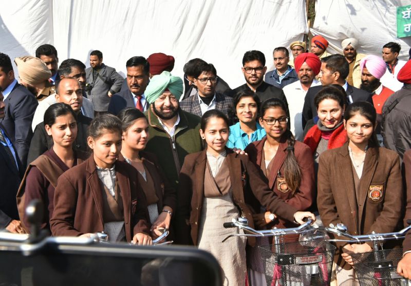 Captain Amarinder Singh distributing cycles to class XI and XII girl students 