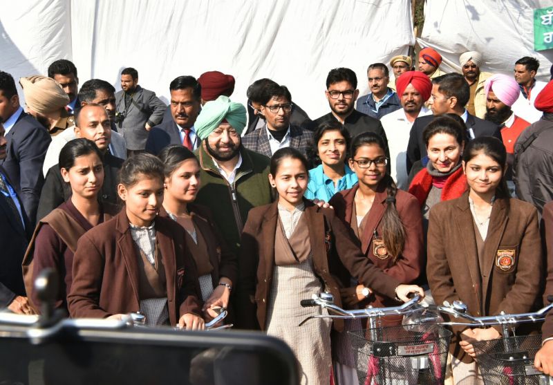 Captain Amarinder Singh distributing cycles to class XI and XII girl students 