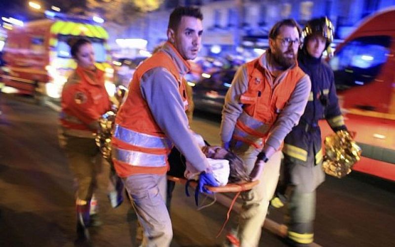 A woman is evacuated from the Bataclan concert hall after a terrorist shooting attack