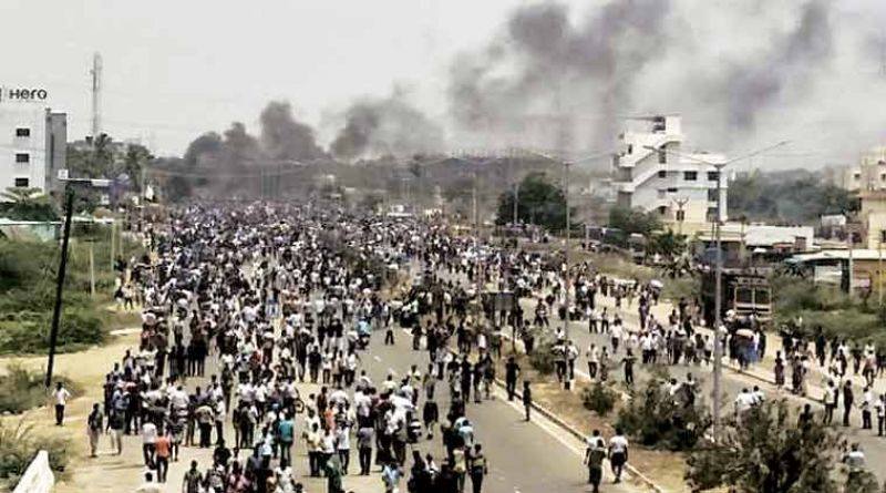Smoke rises from vehicles set on fire during protests in Tuticorin