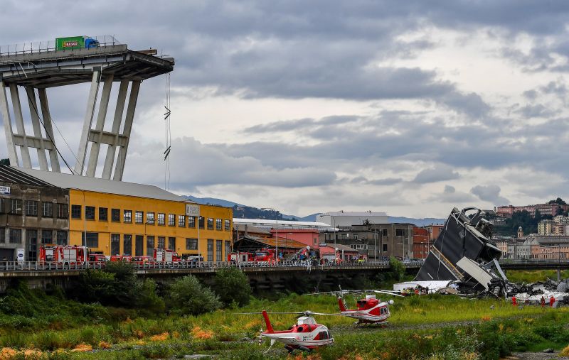 Rescue crews work at the scene of a bridge that collapsed in Genoa