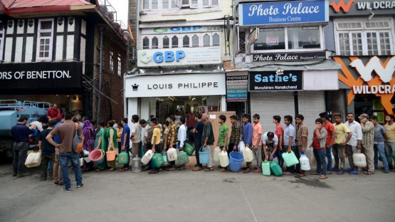 People standing queues to fill water from tanker on Mall Road in Shimla