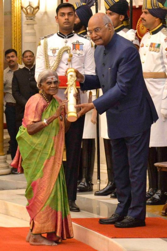 Thimmakka, dressed in a light green sari, with a smiling face