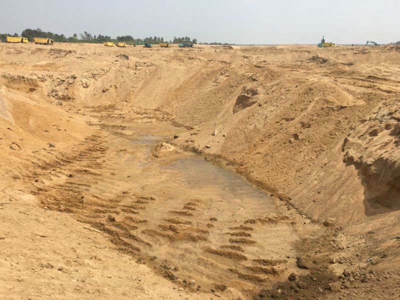 They were sitting under the shadow of a sand mound to save themselves from heat