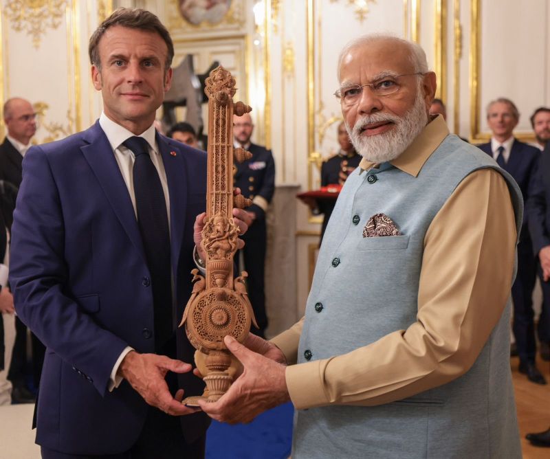 PM Narendra Modi presented a Sitar made of sandalwood to French President Emmanuel Macron as a gesture of friendship and cultural exchange. President Macron's wife, Brigitte Macron was also presented with a sandalwood box and other items.
